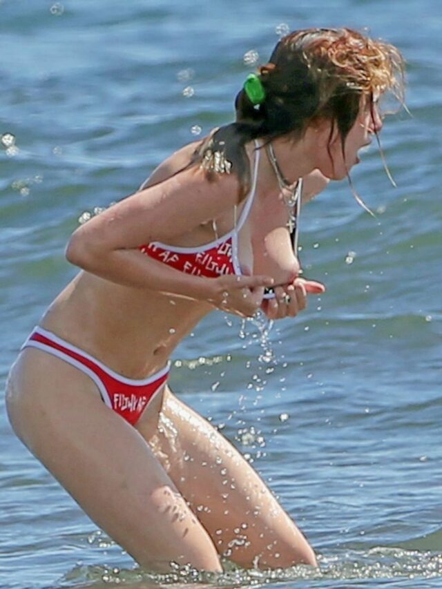 Bella Thorne tit slip in bikini at a beach in Hawaii – June 08, 2018